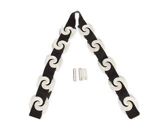 67
A Héctor Aguilar Silver And Suede Concho Belt
1953-1962; Taxco, Mexico
Buckle stamped: HA / Taxco / [Eagle 9] / 940
The black suede belt with ten silver swirled slide/conchos and two-piece buckle

13 pieces
Each concho: 2.25" H x 2.75" W; Buckle: 1.75" H x 1.25" W; Leather belt: 38.25"L x 1.375" H
238.9 grams gross
Estimate: $700 - $900