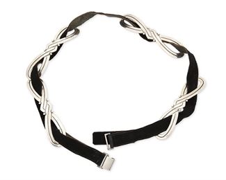 69
A Héctor Aguilar Silver Concho Belt
1948-1962; Taxco, Mexico
Buckle stamped: HA / Taxco / 940 / [Eagle 9]
Four narrow incised silver figure eight conchos on a black suede belt strap with fixed buckle

5 pieces
Each concho: 1" H x 4.75" W; Leather belt: 29" L x 0.75" W
98.5 grams gross
Estimate: $600 - $900