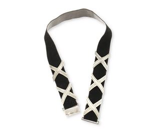 70
A Héctor Aguilar Silver Concho Belt
1948-1962; Taxco, Mexico
Buckle stamped: HA / Taxco / Mexico / 940 / Taller Borda / [Eagle 9]
A belt formed of five X-form slides/conchos on a black suede detachable belt with a clasp buckle

6 pieces
Each concho: 1.5" H x 2.125" W; Belt: 29" L x 1.375" W
129.1 grams gross
Estimate: $700 - $900