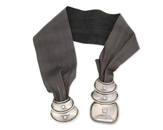 71
A Héctor Aguilar "Armadillo" Silver Belt Buckle With Belt
1940-1945; Taxco, Mexico
Stamped: HA / Taxco / 940
A two-piece clasp belt buckle of graduated hammered silver concave discs with rivet accents and ridged edges, attached to a removable soft black leather belt

3 pieces
Buckle: 2.75" H x 6.25" W; Leather belt: 30.75" L x 3.75" H
119 grams gross
Estimate: $500 - $700