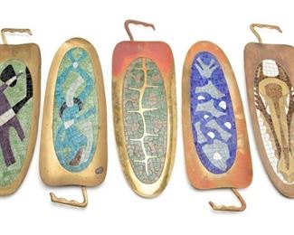 83
A Group Of Salvador Terán Mosaic And Brass Pepper Plates
Circa 1950s; Mexico
Two marked: Handwrought / Salvador / Hecho en Mexico; Three stamped/inscribed: Mexico
Each pepper-shaped brass tray with a polychrome glass mosaic center panel depicting human and animal motifs, 5 pieces
Each: 21.5" H x 7.75" W x 1.25" D approximately
Estimate: $500 - $700