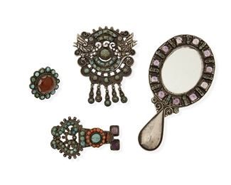 94
A Group Of Matl Silver And Hardstone Jewelry Items, By Matilde Poulat
Four works:

A small hand mirror with a set green stone and amethyst border
1934-1960; Mexico City, Mexico
Stamped: Matl / M. REG / 142093 / Mexico / 925;
5" H x 2.5" W

A filigree brooch with doves and set-turquoise above an articulated cloud with dangles
1934-1960; Mexico City, Mexico
Stamped: Matl
3" H x 2.5" W

An openwork brooch set with amethyst, turquoise, and coral
1934-1960; Mexico City, Mexico
Stamped: Matl
2.5" H x 1.5" W

A round ring with orange stone cabochon surrounded by small turquoise stones
1934-1960; Mexico City, Mexico
Stamped: Matl
Ring size: 8

4 pieces
99.7 grams
Estimate: $600 - $900