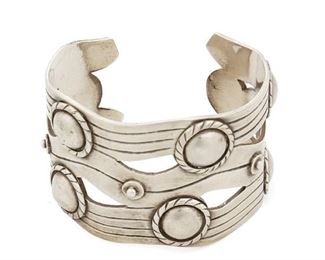105
A William Spratling "River Of Life" Silver Cuff Bracelet
1933-1939, First Design Period; Taxco, Mexico
Stamped "WS" for William Spratling; Further stamped: Taxco / Mexico / 980
Designed as silver waves with roped Aztec rings
7" total inner C x 1.75" H, wrist opening: 1"
105.0 grams
Estimate: $1,000 - $1,500