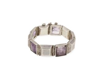 109
A William Spratling Silver And Amethyst Bracelet
1940-1944, First Design Period; Taxco, Mexico
Stamped: Spratling Silver / Made in Mexico
A bracelet with alternating square silver and set amethyst links with a pin clasp and chain guard
7.5" L x 0.75" H
55.7 grams
Estimate: $800 - $1,200