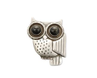 122
A William Spratling Silver And Obsidian Brooch
1940-1946, First Design Period; Taxco, Mexico
Stamped for William Spratling; Further stamped; Made in Mexico / Silver
A stylized owl brooch with two obsidian cabochon gem-set eyes
2.25" H x 1.75" W
34.0 grams
Estimate: $400 - $600