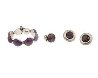 131
A Group Of William Spratling Silver And Amethyst Jewelry
1940-1946, First Design Period; Taxco, Mexico
Each stamped for William Spratling; Bracelet stamped: Taxco / 980 / Made in Mexico; Ring and earrings stamped: Made in Mexico / Silver
Comprised of a cabochon amethyst set bracelet (7" L x 0.75" H); a pair of round silver with central amethyst cabochon screw-back ear clips (1.125" Dia.) and a cabochon set ring (ring size: 8.25)

4 pieces
97.5 grams gross
Estimate: $700 - $900