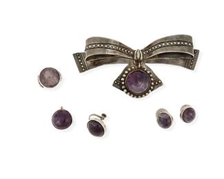 133
A Group Of William Spratling Silver And Amethyst Jewelry
1933-1939 and 1940-1946, First Design Period; Taxco, Mexico
Each stamped for William Spratling; Three stamped: Made in Mexico; One stamped: Taxco / 980
Comprised of four works set with round amethyst cabochon stones, comprising an amethyst bow brooch (2" H x 4.5" W), a pair of cufflinks (0.625" Dia.), a pair of screw-back earrings (0.75" Dia.) and a ring (ring size: 5.5)

6 pieces
83.0 grams gross
Estimate: $500 - $700