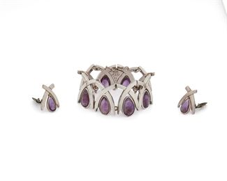152
A Set Of Antonio Pineda Sterling Silver And Amethyst Jewelry
1953-1979; Taxco, Mexico
Each with crown mark for Antonio Pineda; Further stamped: [Eagle 17] / Hecho en Mexico / Silver / 970 / ZZ700
Comprising a bracelet with stylized "X" links set with teardrop cabochon amethysts (7" L x 1.25" W) and with a pair of matching clip-back earrings (1" L x 0.75" W)

3 pieces
116.5 grams
Estimate: $800 - $1,200