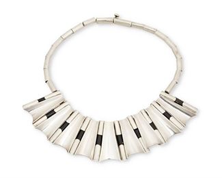 153
An Antonio Pineda Silver And Onyx Necklace
1953-1979; Taxco, Mexico
Stamped with crown mark for Antonio Pineda and Eagle 17; Further stamped: Hecho en Mexico / Silver / 970 / YY
Comprising tubular silver and onyx segments alternating with concave tapering silver panels, inspired by roof tiles
16.75" L x 1.75" H
210.0 grams
Estimate: $1,000 - $2,000