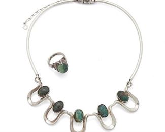 160
Two Antonio Pineda Sterling Silver And Hardstone Jewelry Pieces
Two works:

A wire collar necklace suspending undulating silver shapes set with oval green stone cabochons, with clasp closure and chain guard
1953-1979; Taxco, Mexico
Crown mark for Antonio Pineda; Further stamped: [Eagle 17] / 970
16.5" L x 1.125" H

A ring with similar style claw mount holding an oval green stone cabochon
1953-1979; Taxco, Mexico
Crown mark for Antonio Pineda; Further stamped: [Eagle 208] / [illegible 9__]
Ring size: 6.75

2 pieces
60.8 grams gross
Estimate: $600 - $800