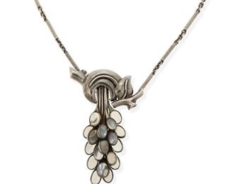 170
An Antonio Pineda Silver And Moonstone Pendant And Chain
1962-1963 and 1953-1979; Taxco, Mexico
Each stamped with crown for Antonio Pineda / Hecho en Mexico; Pendant further stamped: [Eagle 17] / 658; Clasp further stamped: Los Castillo Soc Coop Scl Sec 2 / 970 / [Eagle 3]
A pendant/brooch of a stylized branch suspending a cluster of set moonstones with attached chain
20" L x 2.5" H
43.0 grams
Estimate: $700 - $900