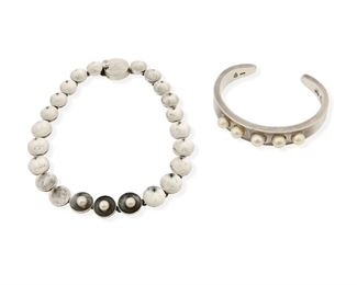 177
An Set Of Antonio Pineda Silver And Pearl Jewelry
1953-1979; Taxco, Mexico
Each stamped for Mexico and crown mark of Antonio Pineda / 970; Necklace: Sterling / [Eagle 17] / Silver; Cuff: Taxco / VJ / [Eagle 3]
A silver disk choker necklace with three inset pearls and a cuff bracelet accented with five pearls

2 pieces
Necklace: 11.375" L x 0.5" H; Cuff: 6.25" total inner C x 0.5" H, wrist opening: 1"
112.5 grams
Estimate: $600 - $800