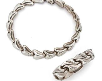 176
Two Antonio Pineda Sterling Silver Jewelry Items
Two works:

A stylized heart link collar necklace with clasp closure
1953-1979; Taxco, Mexico
Crown mark for Antonio Pineda; Further stamped: Hecho en Mexico / 970 / YY523 / [Eagle 17]
16" L x 0.75" H

A bracelet consisting of abstract wave links with clasp closure and chain guard
1953-1979; Taxco, Mexico
Crown mark for Antonio Pineda; Further stamped: Hecho en Mexico / 970 / Los Castillo / Soc Coop SCL Sec 2 / ZZ777 / [Eagle 58]
7.75" L x 1" H

2 pieces
204.3 grams gross
Estimate: $1,000 - $2,000