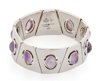 199
An Antonio Pineda Sterling Silver And Amethyst Bracelet
1953-1979; Taxco, Mexico
Crown mark for Antonio Pineda; Further stamped: [Eagle 17] / Hecho en Mexico / 970 / Silver
Designed with trapezoid links, each set with an oval cabochon amethyst
6.45" L x 1.85" W
79 grams
Estimate: $700 - $900