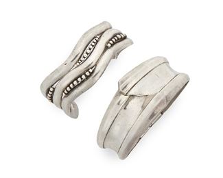 214
Two Antonio Pineda Sterling Silver Bracelets
Two works:

A wave-style cuff with multiple dot elements
1962-1963; Taxco, Mexico
Crown mark for Antonio Pineda; Further stamped: Los Castillo / Sec 2 [obscured Soc Coop Scl] / 925 / Hecho en Mexico / [Eagle 3]
6.875" total inner C x 1" H, wrist opening: 1.5"

A tapered architectural concave hinged bangle
1953-1979; Taxco, Mexico
Crown mark for Antonio Pineda; Further stamped: 970 / Sterling / Mexico / [Eagle 17]
7" inner C x 0.5" to 1.25" H

2 pieces
Estimate: $800 - $1,200