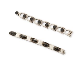 216
Two Antonio Pineda Silver And Onyx Bracelets
Two works:

A hinged silver and onyx bracelet with oval onyx cabochons
1953-1979; Taxco, Mexico
Crown mark for Antonio Pineda; Further stamped: [Eagle 17] / Hecho en Mexico / 970
7" L x 0.5" H

A hinged silver and onyx bracelet set with round onyx stones
1953-1979; Taxco, Mexico
Crown mark for Antonio Pineda; Further stamped: [Eagle 3] / Taxco / Mexico / VJ
7.25" L x 0.75" H

2 pieces
111.9 grams gross
Estimate: $1,000 - $1,500