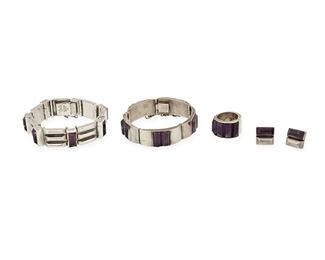 218
A Group Of Antonio Pineda Silver And Amethyst Jewelry
Four works:

A bracelet with three-bar links alternating with set amethyst links
1953-1979; Taxco, Mexico
Further stamped: [Eagle 17] / Hecho en Mexico / 970
7.5 " L x 0.75" H

A bracelet with narrow rectangular links with center inset bar amethysts
1953-1979; Taxco, Mexico
Marked for Antonio Pineda; Further stamped: [Eagle 17] / Hecho en Mexico / 970 / Silver / ZZ302
7" L x 0.675" H

A hinged ring with inset bar amethysts
1953-1979; Taxco, Mexico
Marked for Antonio Pineda; Further stamped: [Eagle 17] / Hecho en Mexico / Silver
Ring size: 7.5

A pair of screw-back earrings
1948-1953; Taxco, Mexico
Marked for Antonio Pineda; Further stamped: Silver by Tono / [Eagle 17] / Hecho en Mexico
0.75" L

5 pieces
Estimate: $1,200 - $1,800