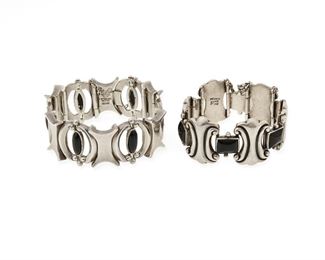 222
A Set Of Antonio Pineda Silver And Onyx Bracelets
Two works:

One bracelet featuring rectangular stone set onyx links alternating with incised foliate-style 'X' links, with clap closure and chain guard
1948-1953; Taxco, Mexico
Stamped for Antonio Pineda; Further stamped: Silver by Tono / Mexico / [indistinct eagle]
7" L x 1.25" H

One bracelet designed with silver 'X' links alternating with openwork links with oval onyx, with clap closure and chain guard
1953-1979; Taxco, Mexico
Crown mark for Antonio Pineda; Further stamped: Sterling / Mexico / Silver / 970 / [Eagle 17]
7" L x 1"

2 pieces
153.0 grams gross
Estimate: $1,200 - $1,800