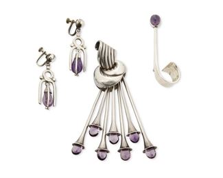 233
A Group Of Antonio Pineda Silver And Amethyst Jewelry
1953 or later; Taxco, Mexico
Each stamped with crown mark for Antonio Pineda; Each variously stamped: Silver / Hecho en Mexico / 970; Brooches: [Eagle 17]
Comprising a stylized knot brooch suspending trumpet-style dangles tipped with amethyst drops (4.25" H x 1.125" W), a modernist abstract amethyst-set pin (2.625" H x 0.75" W), and a pair of screw-back earrings with amethyst dangles (2" L)

4 pieces
77.2 grams gross
Estimate: $400 - $600