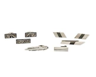 240
A Group Of Antonio Pineda Silver And Hardstone Jewelry
1953-1979; Taxco, Mexico
Each with crown mark for Antonio Pineda; Each variously further stamped: [Eagle 17 or Eagle 3] / Hecho en Mexico / 970 / JVL Taxco / Silver
Comprising two silver tie clips (2" H and 1.25" H), an obsidian money clip (2.25" H), a pair of silver cufflinks with geometric overlay (1.125" H) with matching tie clip (1.25" H), and a pair of hardstone inlay cufflinks (1.25" H)

8 pieces
87.5 grams gross
Estimate: $500 - $700