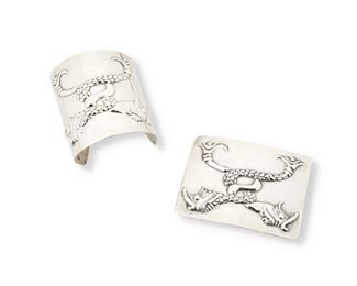 265
Two Hubert Harmon Silver Repoussé Serpent Pieces
1944-1948; Mexico
Each stamped: Hubert Harmon / Made in Mexico / Sterling; Buckle stamped with winged feet for Hubert Harmon
Comprising a wide silver cuff bracelet with a double entwined repoussé fish or serpent design, and a matching belt buckle

2 pieces
Cuff: 7.25" total inner C x 2.75" H; Buckle: 2.625" H x 3.625" W
117.3 grams gross
Estimate: $500 - $700