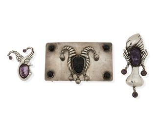 266
Three Hubert Harmon Silver Accessory Items
Three works:

A brooch depicting a swan encircling a carved amethyst head
1942-1948; Taxco, Mexico
Stamped for Hubert Harmon and sterling; Further stamped: [conjoined] HH / Hubertus / Handmade / Taxco / Mexico
2.25" H x 1.875" W

A brooch or pendant of a turbaned figure with a carved amethyst face
1942-1948; Taxco or Mexico City, Mexico
Stamped for Hubert Harmon and sterling; Further stamped: Made in Mexico
4" H x 1.625" W

A silver belt buckle with carved onyx jester face and onyx cabochons to corners
1942-1948; Taxco or Mexico City, Mexico
Stamped for Hubert Harmon and sterling; Further stamped: Made in Mexico
2.625" H x 4.375" W

3 pieces
160.4 grams gross
Estimate: $500 - $700