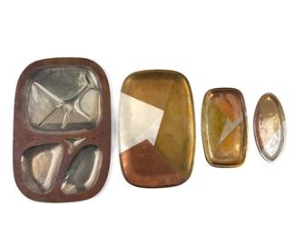 272
A Group Of Los Castillo Mixed-Metal Platters
Third-Quarter 20th Century; Taxco, Mexico <br />
Variously marked: Los Castillo / Taxco / Hecho en Mexico / Handwrought / Made in Mexico / Metales Castillo
Comprising a large meat plate (0.5" H x 21.75" W x 14.75" D), a large serving tray (0.25" H x 17.75" W x 11.75" D), a small rectangular tray (0.25" H x 12" W x 7" D), and a small oval tray (0.25" H x 10.25" W x 5" D), 4 pieces
Estimate: $500 - $700