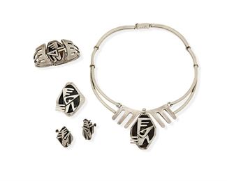 277
A Group Of Salvador Terán Silver Modernist Jewelry
Mid-20th Century; Mexico City, Mexico
Each marked: Salvador [script]; Further variously marked: Mexico / Silver / Sterling / Hecho en Mexico / [with design number]
Designed with abstract figures set to an oxidized shadowbox backing, comprising a hinged collar necklace No. 171 (17.5" L x 2.25" H), a hinged bracelet No. 157 (6.5" L x 1.5" H), a pair of unmarked earrings (1.125" L), and a matching brooch/pendant (2" L x 1.75" W)

5 pieces
159.0 grams gross
Estimate: $600 - $800