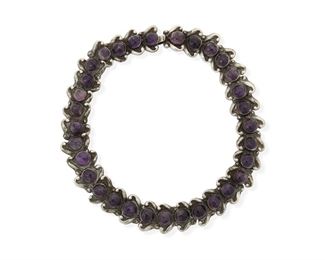 283
A Los Castillo Silver And Amethyst Necklace
1942-1948, Taxco, Mexico
Stamped: Los Castillo / Taxco / Sterling / Made in Mexico
A necklace with each link set with a cabochon amethyst and S-scroll supports with a hooked clasp
16" L x 0.875" H
87.0 grams
Estimate: $400 - $600