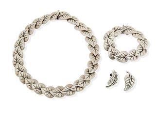 288
A Group Of Los Castillo Silver Foliate Jewelry
Three works:

A link collar necklace with clip closure No. 329
1940 or later; Taxco, Mexico
Stamped: Los Castillo / Taxco / [Eagle 15] / Hecho en Mexico / 32_
15.5" L x 0.75"

A matching link bracelet with clasp closure and chain guard No. 329
1940 or later; Taxco, Mexico
Stamped: Los Castillo / Taxco / [Eagle 15] / Made in Mexico / 925 / 329
6.25" inner C x 0.75" H

A pair of leaf motif screw-back earrings
1940 or later; Taxco, Mexico
Stamped: Los Castillo / Taxco / [Eagle 15] / 09S [obscured]
1.25" H

4 piece
152.8 grams gross
Estimate: $600 - $800