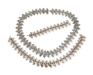 286
A Set Of Los Castillo Silver Jewelry
1939-1945; Taxco, Mexico
Each stamped: Los Castillo / Taxco / 980 / 184; Long necklace further stamped: Made in Mexico
Comprising a long necklace or belt (27.5" L x 1.25: H), a collar necklace (16" L x 1.25" H), and a matching bracelet (7.5" L x 1.25" H), all formed of segmented silver stylized floral links, with fine hook closures

3 pieces
352.4 grams gross
Estimate: $800 - $1,200