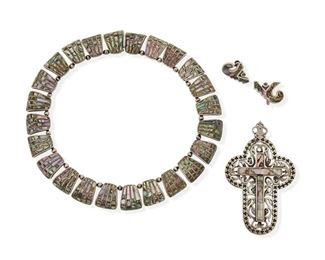 289
A Group Of Los Castillo "Mosaico Azteca" Silver Jewelry
1950-1965; Taxco, Mexico
Each stamped: Los Castillo / Taxco / Mosaico Azteca / Made In Mexico / Sterling / [Eagle 15]; Each further stamped with design number
Designed with inlaid mother-of pearl, comprising a cross pendant with delicate chased openwork No. 118 (3.5" H x 2.125" W), a necklace of curved edge trapezoidal inlaid links No. 230 (14.5" L x 0.75" H), and a pair of abstract inlaid earrings No. 161 (0.75" H x 1" W)

4 pieces
171.3 grams gross
Estimate: $300 - $500