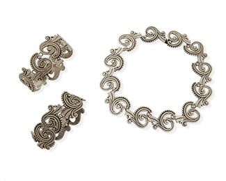 291
A Set Of Los Castillo Silver Jewelry
1942-1948, Taxco, Mexico
Each stamped: Los Castillo / Taxco / Sterling / Made in Mexico / 615 Necklace further stamped: A
Comprising a segmented necklace with arabesque openwork motifs (15" L x 1.125" H) and two matching link bracelets with clasp closure and chain guard (8" L and 7.25" L)

3 pieces
218.9 grams gross
Estimate: $500 - $700