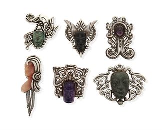 294
A Group Of Los Castillo Hardstone Portrait Brooches
1940-1945 and 1948-1965; Taxco, Mexico
Each stamped: Los Castillo / Taxco / Made in Mexico [but one]
Six works:

A small greenstone face with clasp pin
Further stamped: Sterling
2.75" H x 2.5" W

A large greenstone face with spring pin and pendant rings
Further stamped: 980 / Sterling / 389
2.75" H x 3.625" W

A large purple stone face with spring pin
Further stamped: 980 / 147
2.625" H x 2.5" W

A black onyx face with clasp pin
Further stamped: 980 / 465
2.875" H x 2.5" W

A small purple stone face with spring pin
Further stamped: 980 / 120
3.25" H x 2" W

A pink stone side-view face with clasp pin and chain dangles
Further stamped: [Eagle _5]
2.75" H, with dangles: 4.25" H

6 pieces
329.1 grams gross
Estimate: $600 - $800