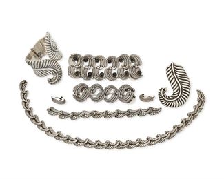 295
A Large Group Of Los Castillo Foliate-Style Silver Jewelry
Seven works:

A double width link bracelet with onyx cabochons No. 817
1940-1965; Taxco, Mexico
Stamped: Los Castillo / Taxco / Made in Mexico / Sterling / 817
7.5" L x 2" H

A smaller link bracelet No. 817
1940-1965; Taxco, Mexico
Stamped: Los Castillo / Taxco / Sterling / Made in Mexico / 817 / [Eagle 15]
6.5" inner C x 1.375" H

A pair of matching earrings No. 817
1940-1965; Taxco, Mexico
Stamped: Los Castillo / Taxco / Sterling / Mexico / 817 / [obscured eagle]
1.125" L

A narrow foliate design link necklace
1940-1965; Taxco, Mexico
Stamped: Los Castillo / Taxco / Sterling / Made in Mexico
17" L x 0.625" H

A matching narrow foliate link bracelet
1940-1965; Taxco, Mexico
Stamped: Los Castillo / Taxco / Sterling / Made in Mexico
8" L x 0.625" H

A foliate design cuff with spring hinge No. 238
1940-1965; Taxco, Mexico
Stamped: Los Castillo / Taxco / 925 / 238; Later etched: Silver / Mexico
6.125" inner C x 3.75" H

A matc