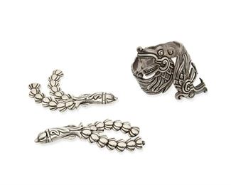 302
A Group Of Los Castillo Silver Jewelry
Two works:

A two-headed plumed serpent cuff bracelet with spring hinge
1950 or later; Taxco, Mexico
Stamped: Los Castillo / Taxco / Made in Mexico / Sterling / 425 / [faint eagle]
7.25" inner C x 4" H

A pair of floral motif collar brooches, each with pin backing and a hook and eye tail to link together
1950 or later; Taxco, Mexico
Stamped: Los Castillo / Taxco / Made in Mexico / Sterling / 181 / [Eagle 15]
Each: 0.75" H x 4.675" L

3 pieces
151.1 grams gross
Estimate: $500 - $700