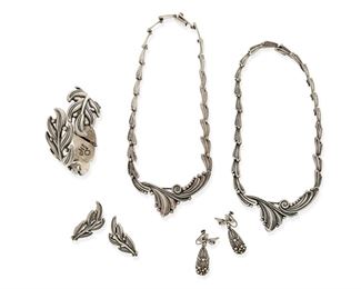 319
A Group Of Margot De Taxco Silver Jewelry
1948-1978; Taxco, Mexico
Each stamped: Margot de Taxco / Sterling / Made in Mexico / [Eagle 16]; Each further stamped with design number
Designed by Margot Van Voorhies, comprising two stylized foliate design necklaces No. 5337 (15" L x 1.25" H and 15.5" L x 1.5" H), a stylized leaf design hinged bangle No. 5474 (6.5" inner C x 1.5" H) with matching ear clips (1.75" L), and a pair of stylized flower and bow ear clips No. 5316 (1.625" L)

7 pieces
215.3 grams gross
Estimate: $700 - $900