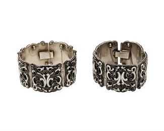 326
A Pair Of Margot De Taxco "Scrolls In Circles" Silver And Enamel Hinged Bangle Bracelets
1955-1978; Taxco, Mexico
Each stamped: Margot de Taxco / Sterling / Made in Mexico / [Eagle 16] / 5583
Designed by Margot Van Voorhies, comprising a matching pair of black and white elaborate overlay enamel hinged bangle bracelets No. 5583

2 pieces
Each: 6.5 " L x 1.125" H
201.0 grams gross
Estimate: $600 - $800