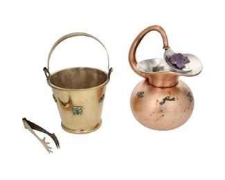 347
Two Los Castillo Metal Bar Accessories
Third-Quarter 20th Century
Each marked: Los Castillo / Taxco / Handwrought / Hecho en Mexico
Comprising a copper water pitcher with frog motif turquoise inlay and carved amethyst frog to spout (9.75" H x 6.25" W x 5.75" D) and a brass ice bucket with tongs and strainer set with frog motif turquoise inlay (9.25" H x 6.375" W x 5.875" D), 2 pieces
Estimate: $500 - $700