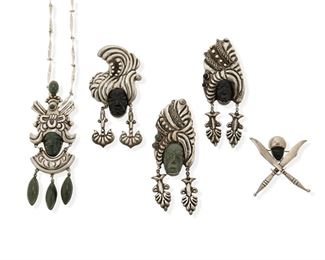 354
A Group Of JP Silver And Hardstone Jewelry
Mid-20th Century; Mexico
Four stamped: J.P. / Silver / Mexico; One further stamped: [Eagle 1] / 925; Chain marked: Sterling / © / Sara; Sword pin stamped: H. Santana / Silver / Mexico
Comprising a large elaborate warrior pendant/brooch with green stone cabochon drops and carved portrait head with twisted link chain attached to a brooch adapter (brooch: 4.75" H x 1.75" W; chain: 32" L); two similarly designed hardstone and silver portrait brooches with carved stone mask, embellished turban, cabochon accents, and ear drops, one in onyx and one in green stone (each: 4.25" H x 1.5" W); a different style carved onyx and silver portrait brooch with ear drops (4" H x 2" W); and a crossed swords and carved onyx mask brooch (2.25" H x 2.125" W)

6 pieces
197.1 grams gross
Estimate: $200 - $300