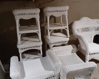 White wicker outdoor furniture.  Tables, benches