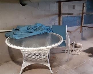 Table with blue chairs, umbrella and umbrella stand