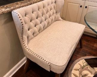 Tufted dining bench with nailhead accent by Ashley Furniture