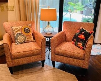 Pair of side chairs, stone colored background with burnt red/orange swirl print (close up in next photo)
