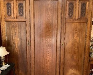 Large armoire retrofitted for storage with shelves breaks down into 3 pieces