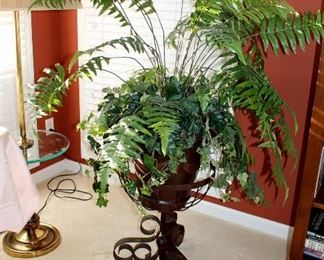 Large silk fern plant in iron stand