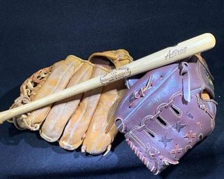 Two baseball mitts and Astros mini wooden bat
