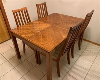 Dining table with four chairs/ comes with one leaf and pads