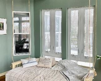 This bed is not actually swinging from ceiling. It is a day bed.