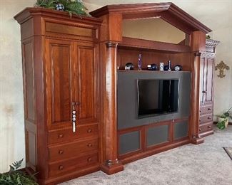 Custom made cherry wood entertainment center. The TV insert can be changed based on size of TV.  It aslo houses sound system speakers. Cost of homeowner to build customized center was $30,000.